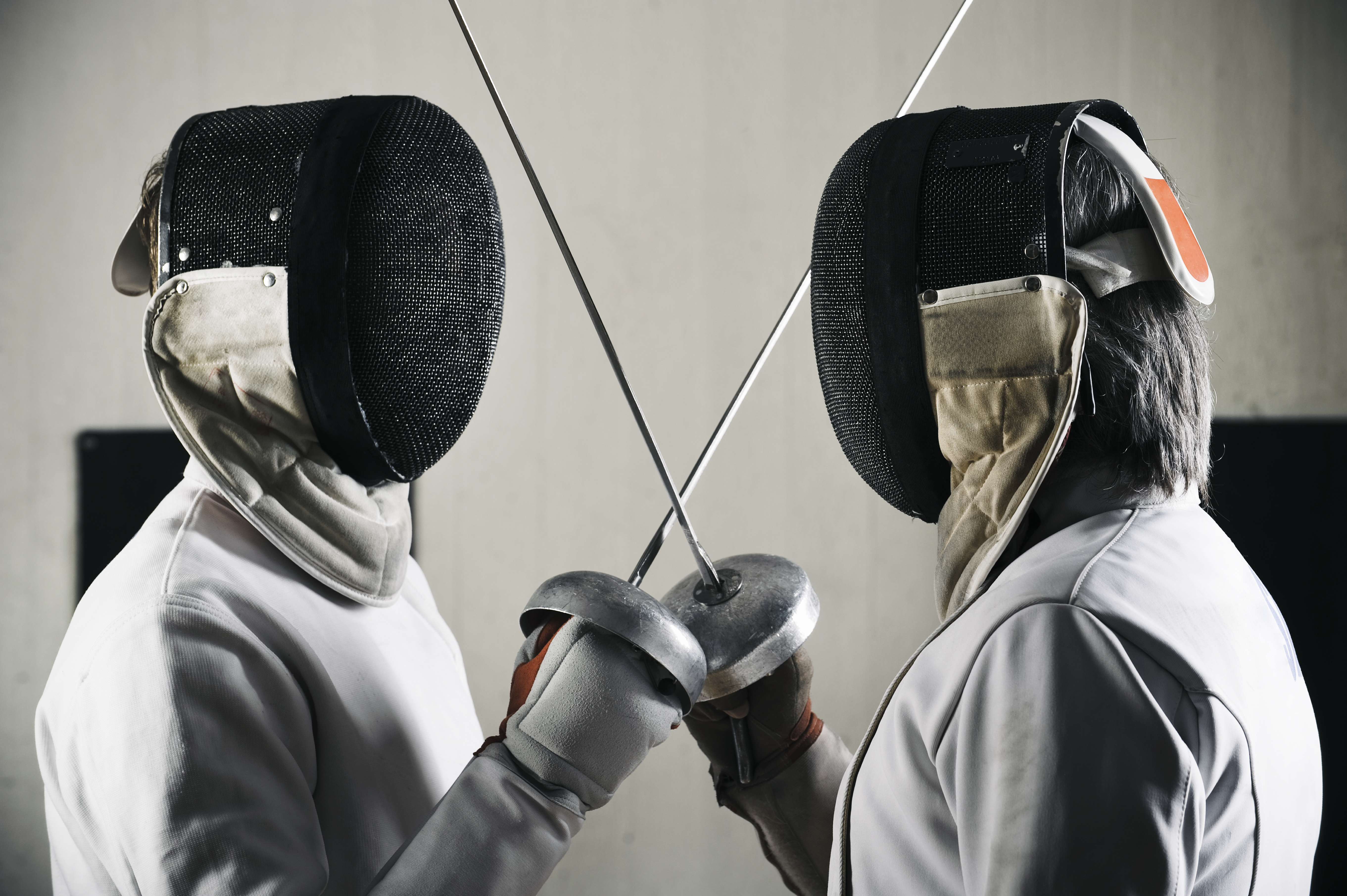 Two fencers facing off in competition